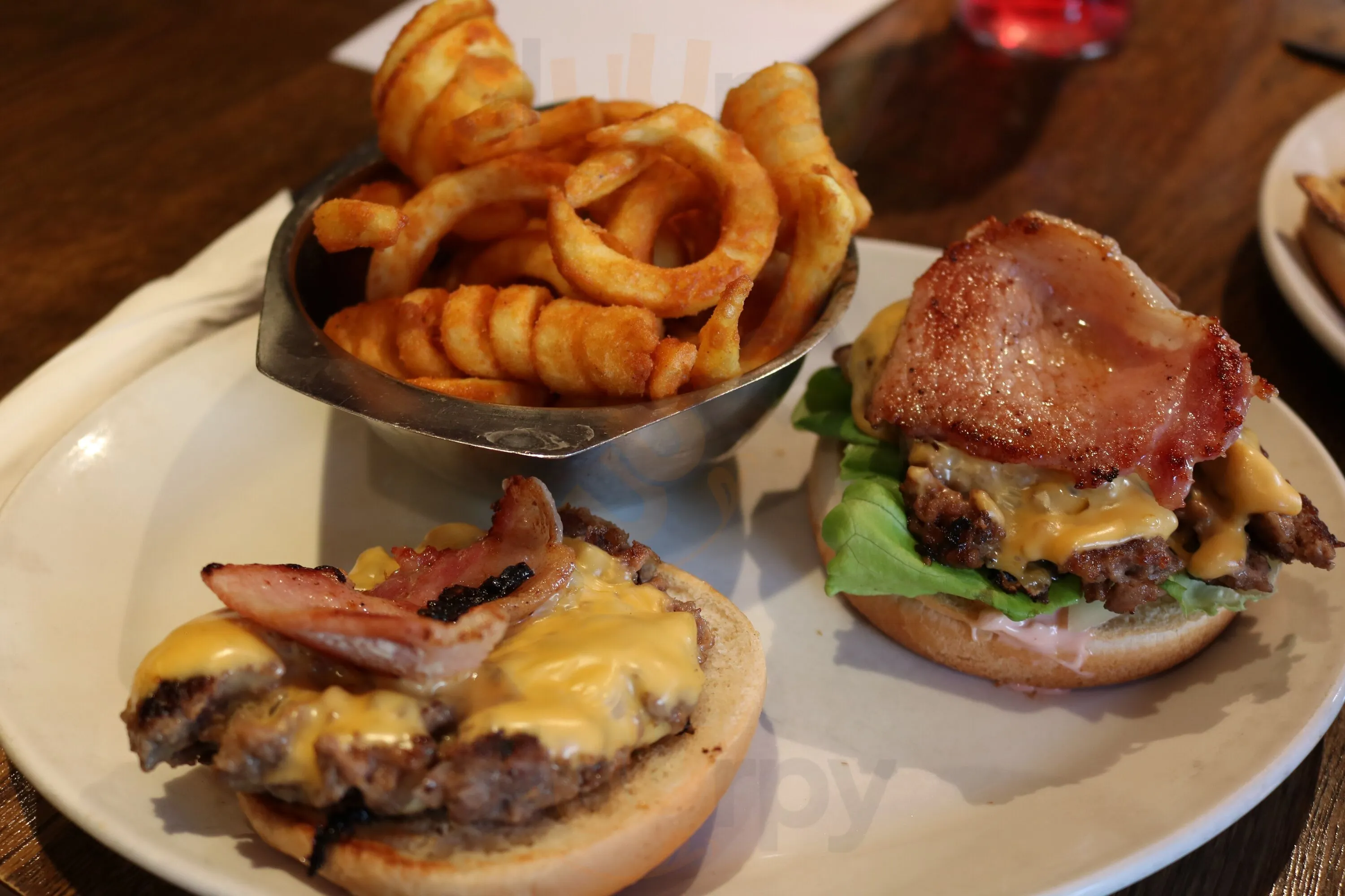 Loaded bacon cheeseburger with curly fries